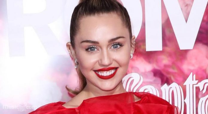 Miley Cyrus wears a red devil suit with sheer
