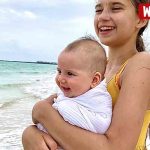 Karolina with newborn baby brother’s reaction to the ocean Karolina with newborn baby brother's reaction to the ocean