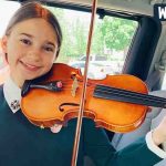 Karolina Playing violin on her knees in the car Karolina Playing violin on her knees in the car